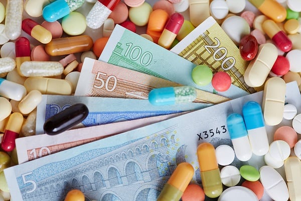Different Euro money bills on pills and colorful medicine - SI ...